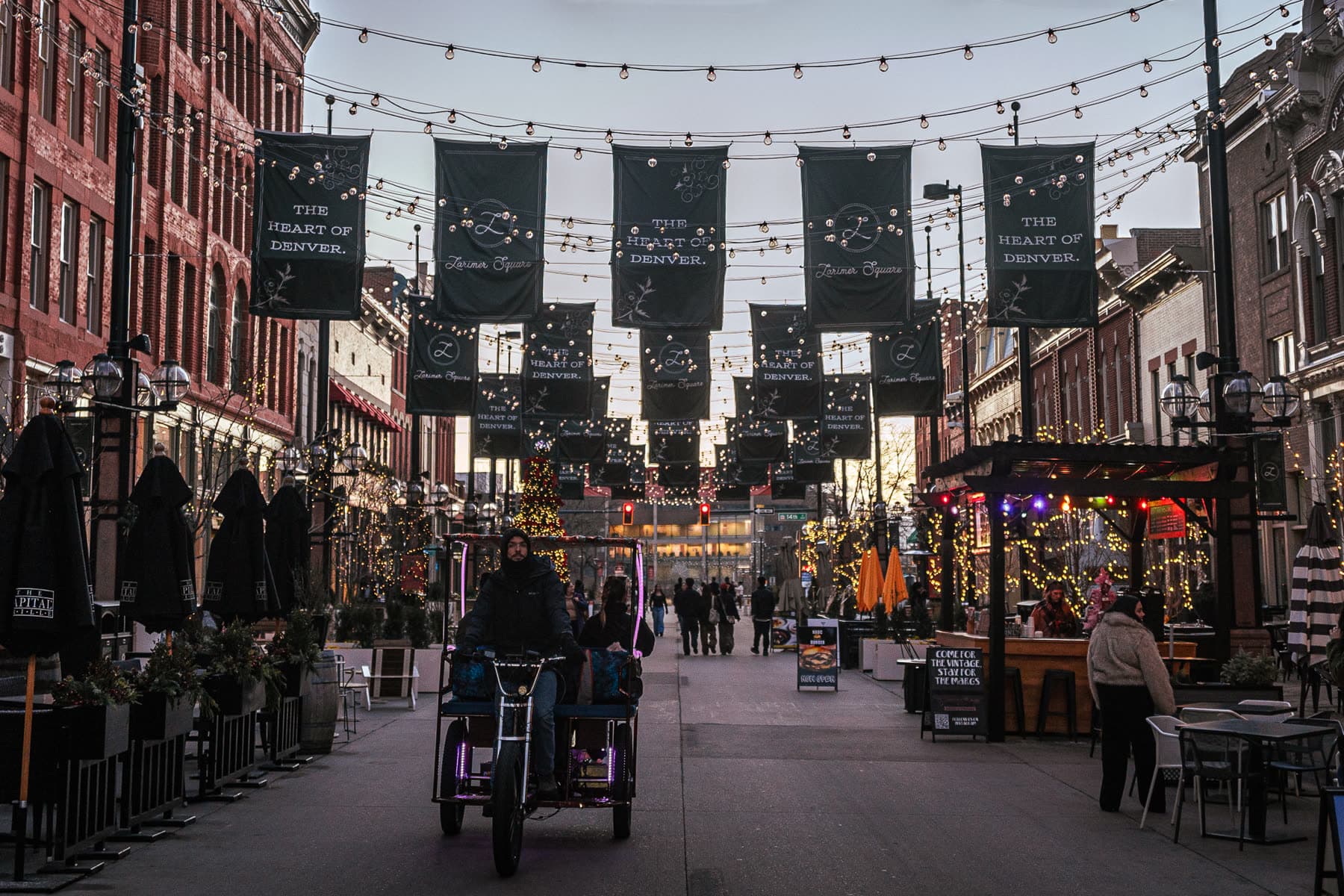 Restaurant patios and string lights along Larimer Square in Denver